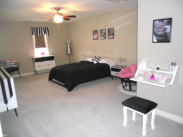 bedroom with a ceiling fan, light colored carpet, and baseboards