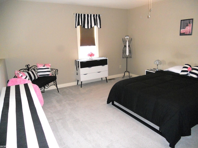 bedroom with light carpet and baseboards