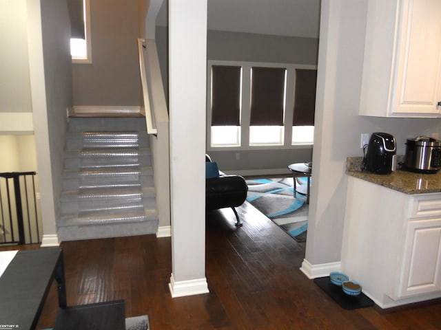 stairs featuring baseboards and hardwood / wood-style floors