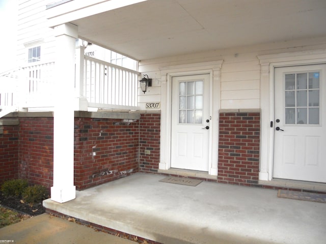 entrance to property with brick siding