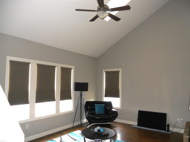 office featuring a healthy amount of sunlight, baseboards, dark wood finished floors, and a ceiling fan