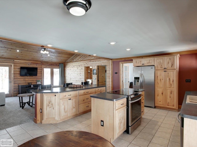 kitchen with stainless steel appliances, a wealth of natural light, log walls, light brown cabinetry, and dark countertops