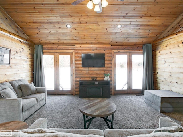 carpeted living room featuring vaulted ceiling, french doors, wooden ceiling, and rustic walls