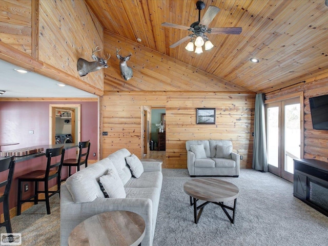 carpeted living area with vaulted ceiling, ceiling fan, and wooden ceiling