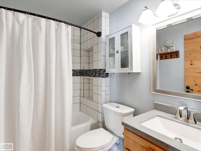 bathroom featuring shower / bathtub combination with curtain, vanity, and toilet