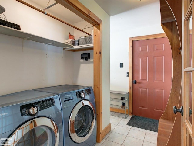 laundry room featuring laundry area, separate washer and dryer, and light tile patterned flooring