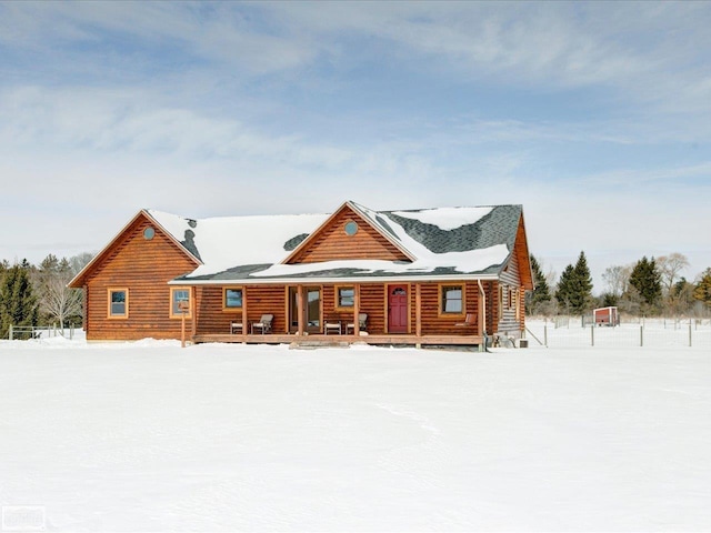 log home with log siding and a porch