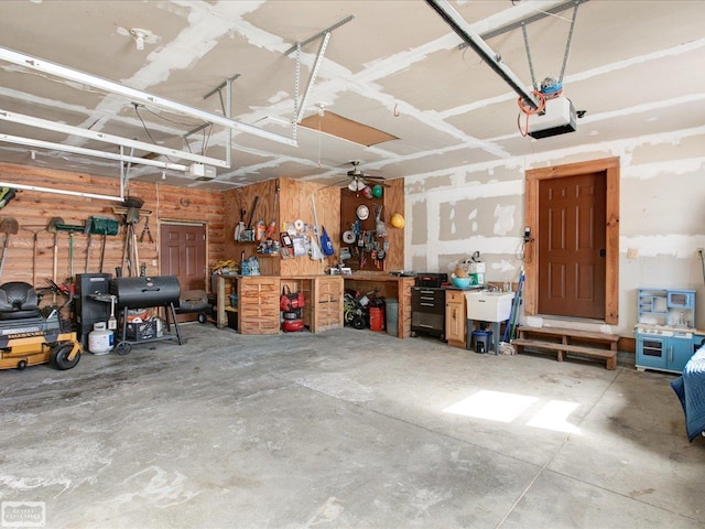 garage with a garage door opener and a workshop area