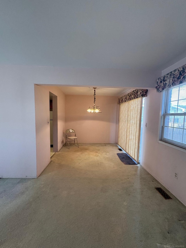 spare room featuring carpet floors and visible vents