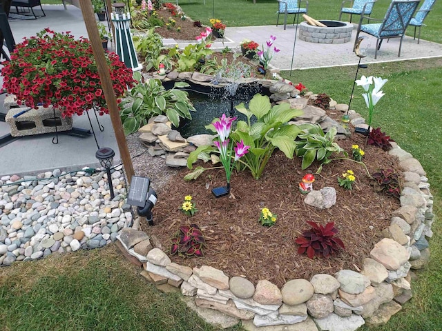 view of yard with an outdoor fire pit and a patio