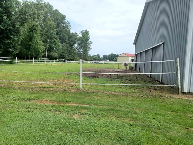 view of yard featuring an outbuilding and a rural view