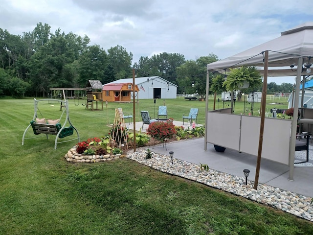 view of yard with playground community and a patio