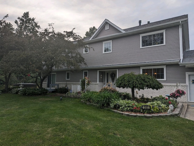 view of front of property featuring brick siding and a front yard