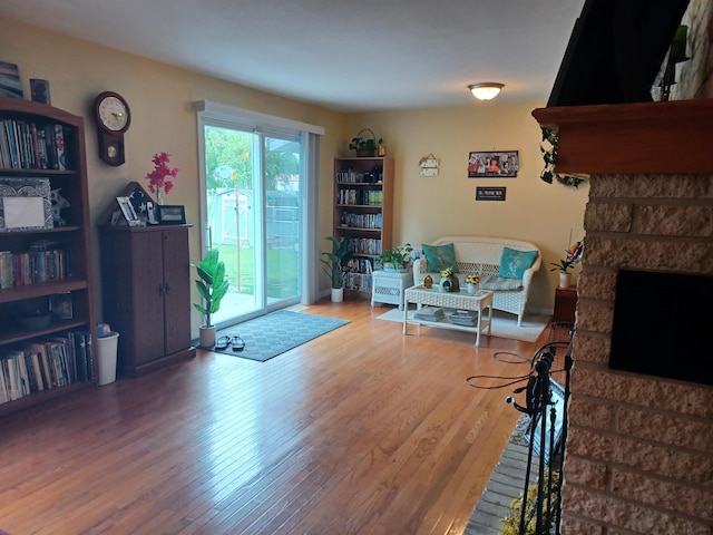 living area featuring a fireplace and wood finished floors