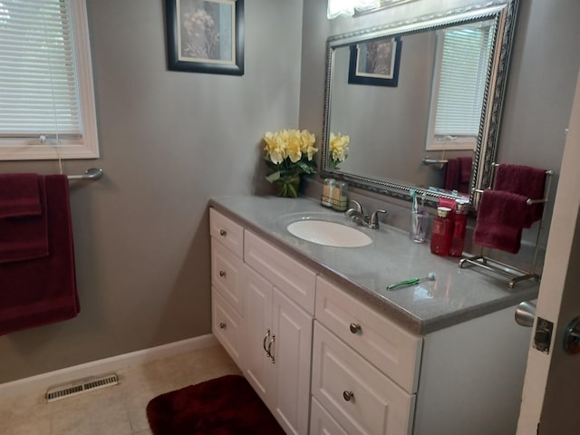 bathroom with tile patterned floors, vanity, visible vents, and baseboards