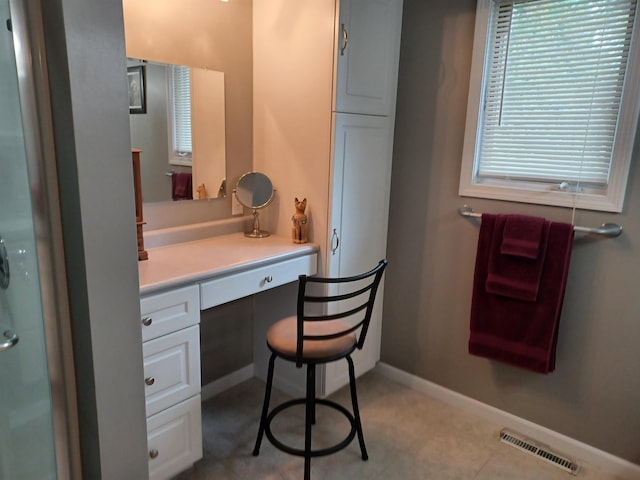 bathroom with vanity, visible vents, and baseboards