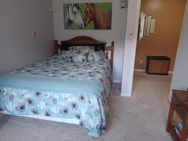 bedroom featuring carpet and baseboards