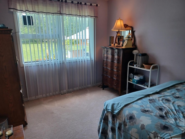 carpeted bedroom with visible vents