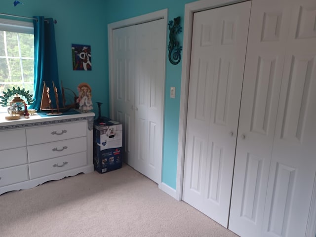 bedroom featuring light colored carpet