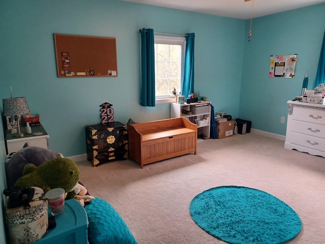 bedroom featuring carpet and baseboards