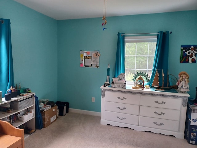 bedroom with light carpet and baseboards