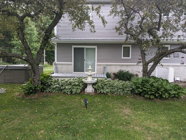 view of front of home with brick siding and a front yard