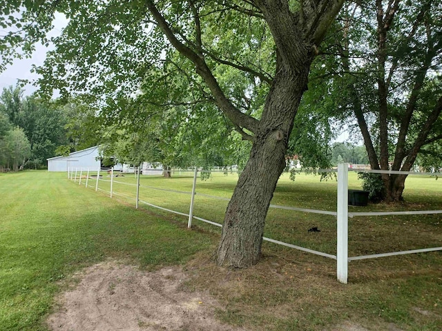 view of yard with a pole building and fence