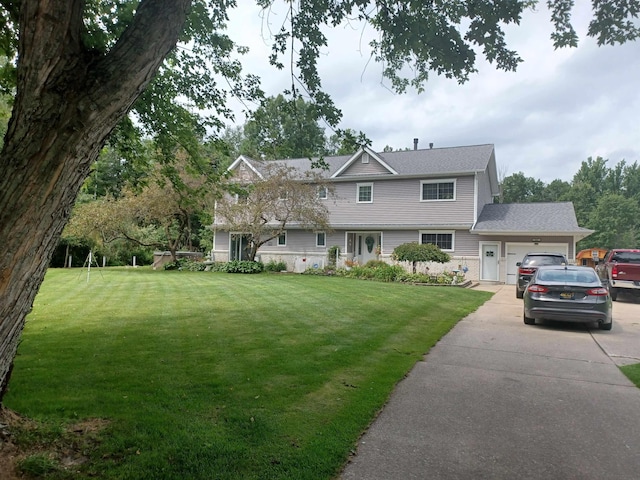 view of front facade with a garage, concrete driveway, and a front yard