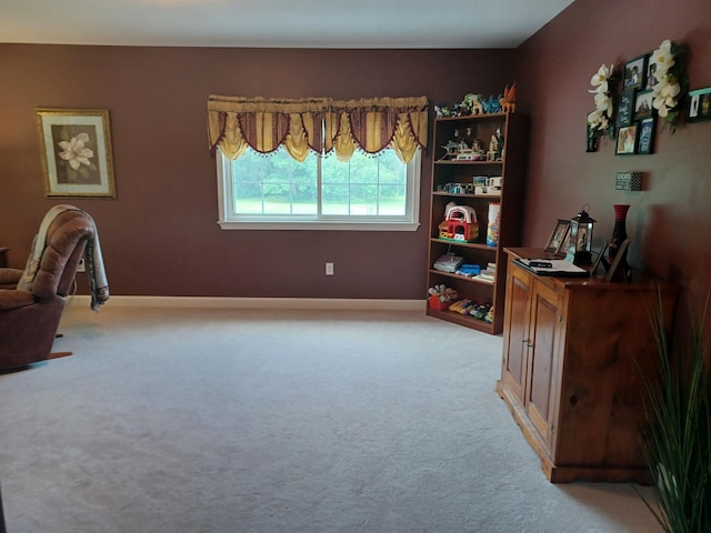 office space with baseboards and light colored carpet