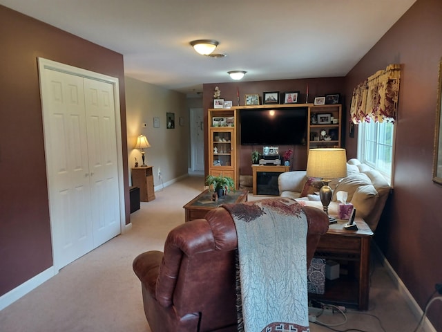 carpeted living room featuring baseboards