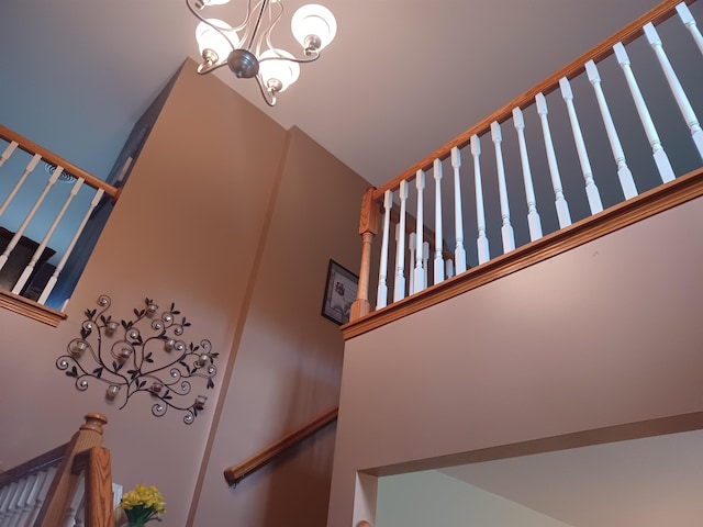 staircase with a chandelier