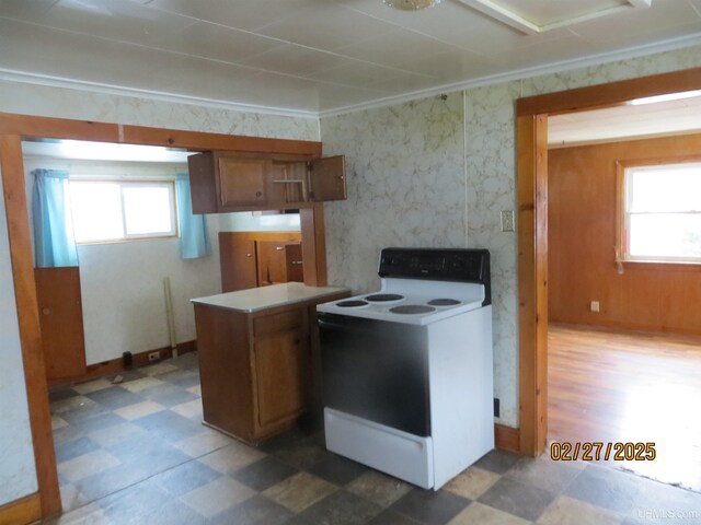 kitchen featuring white electric stove, a wealth of natural light, and tile patterned floors