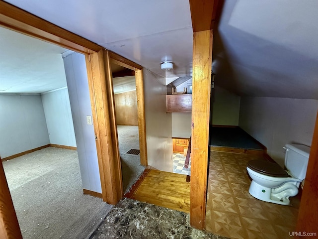 additional living space featuring lofted ceiling and baseboards