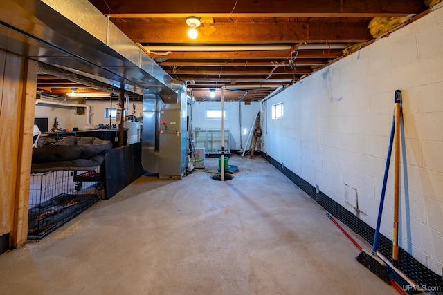 basement with water heater and heating unit