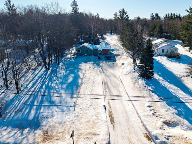 snowy aerial view featuring a view of trees