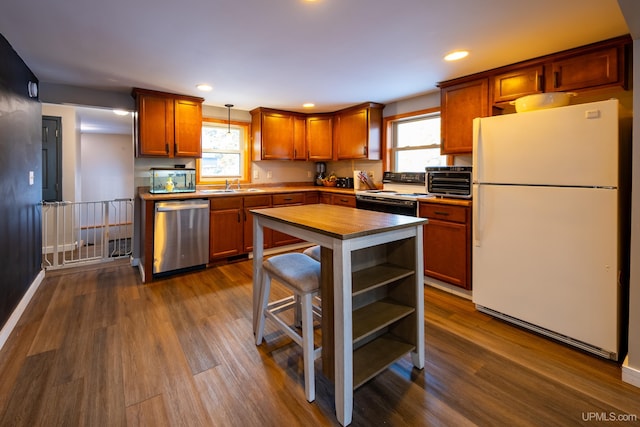 kitchen with dishwasher, electric stove, dark wood-style flooring, and freestanding refrigerator