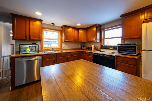 kitchen featuring a sink, plenty of natural light, electric range oven, and stainless steel dishwasher