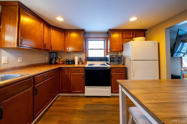 kitchen featuring electric stove, dark wood finished floors, freestanding refrigerator, and recessed lighting