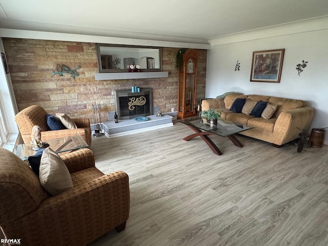 living area with a fireplace and wood finished floors