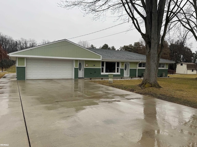 ranch-style home featuring a garage, a front lawn, concrete driveway, and brick siding