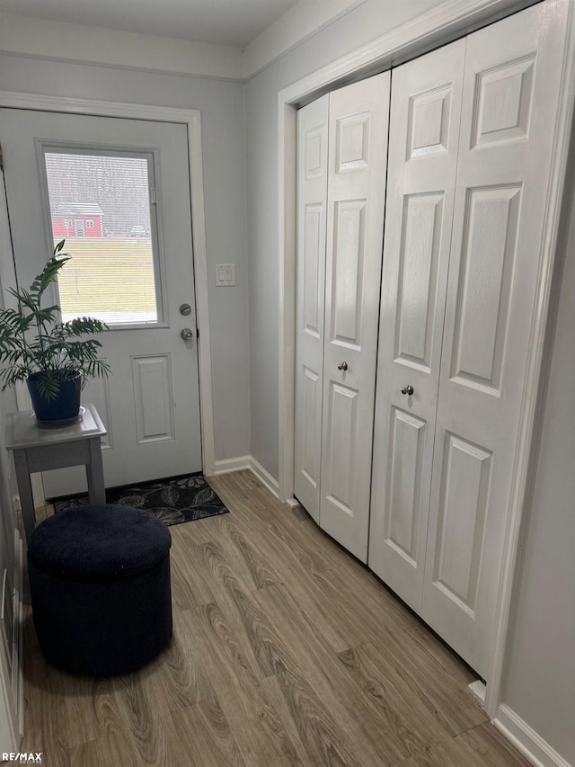 entryway featuring wood finished floors and baseboards