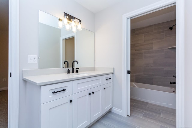 full bath with shower / bath combination, vanity, and baseboards