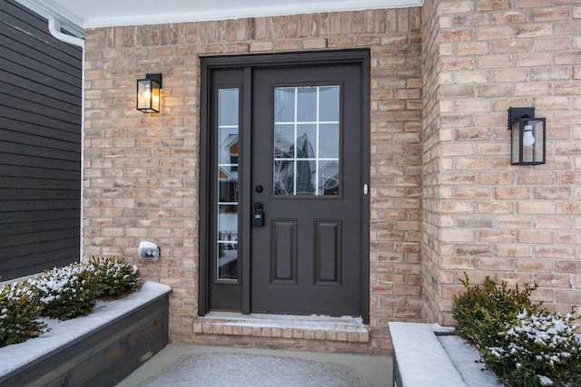 property entrance with brick siding