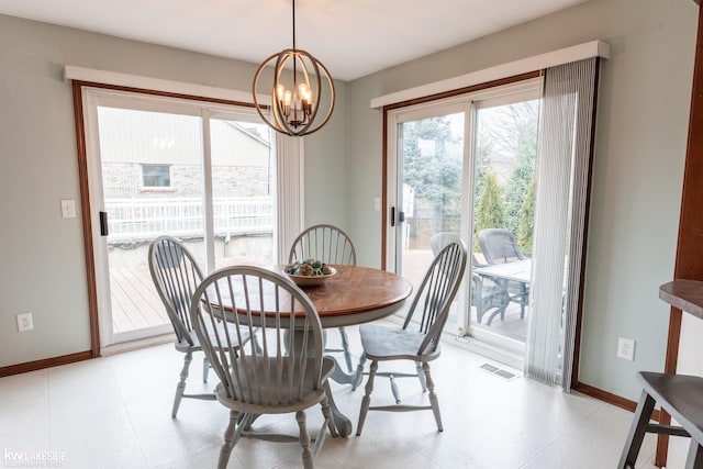 dining space with a chandelier, visible vents, and baseboards