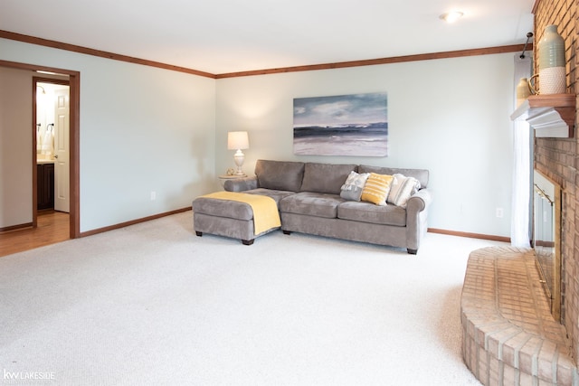 living room featuring ornamental molding, carpet, a fireplace, and baseboards