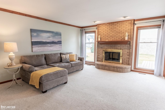 carpeted living room with ornamental molding, visible vents, a fireplace, and baseboards