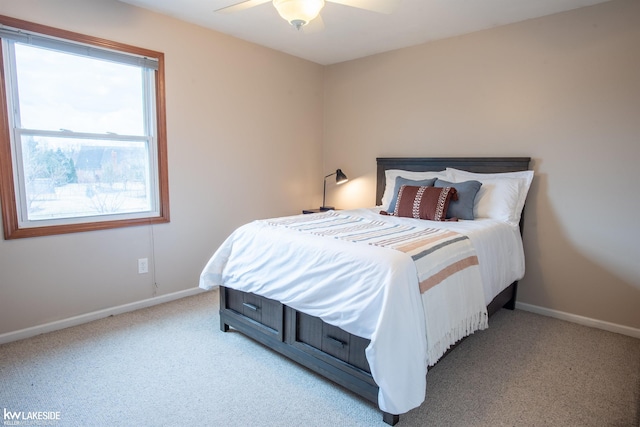 bedroom featuring baseboards, a ceiling fan, and light colored carpet