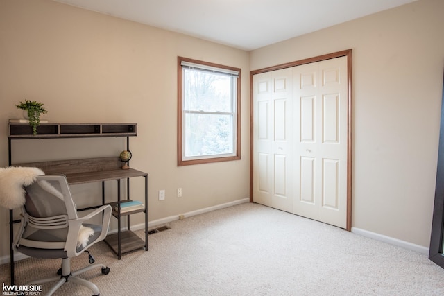 carpeted home office with visible vents and baseboards