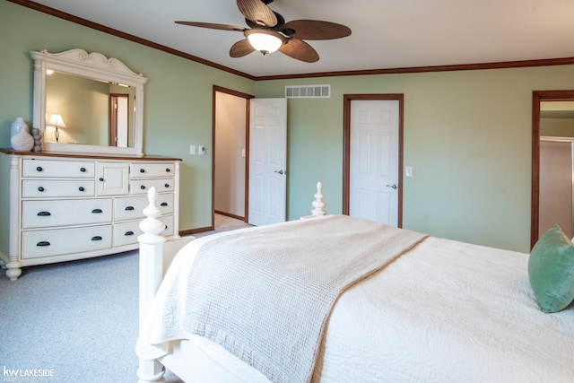 bedroom featuring ceiling fan, carpet floors, visible vents, baseboards, and ornamental molding