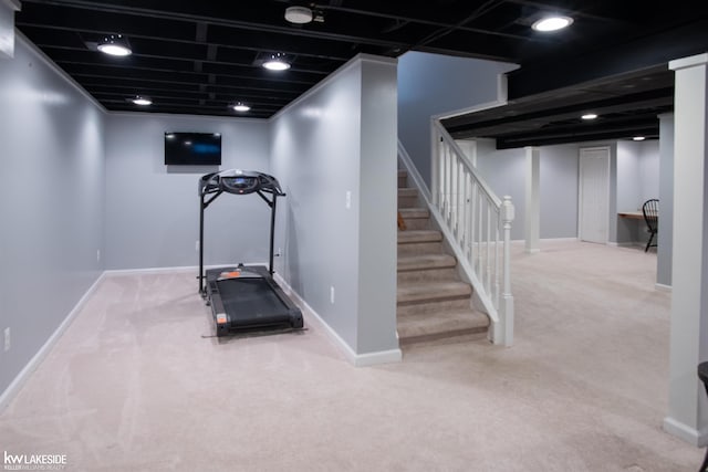 workout area with carpet flooring and baseboards